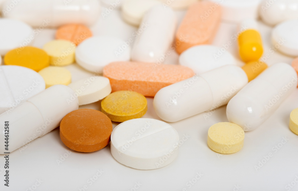 Lots of scattered pills, capsules on white background with copy space flat lay. Medicine and pharmacy concept. Multicolored Lots of scattered pills, capsules on white background with copy space flat lay. Medicine and pharmacy concept. Multicolored