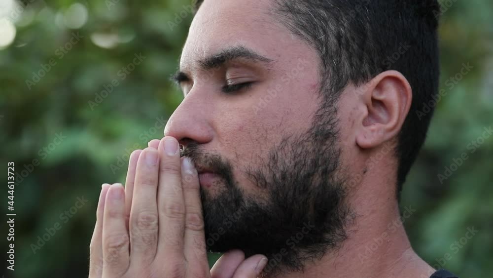 Spiritual hispanic man feeling freedom, taking a deep breath outside