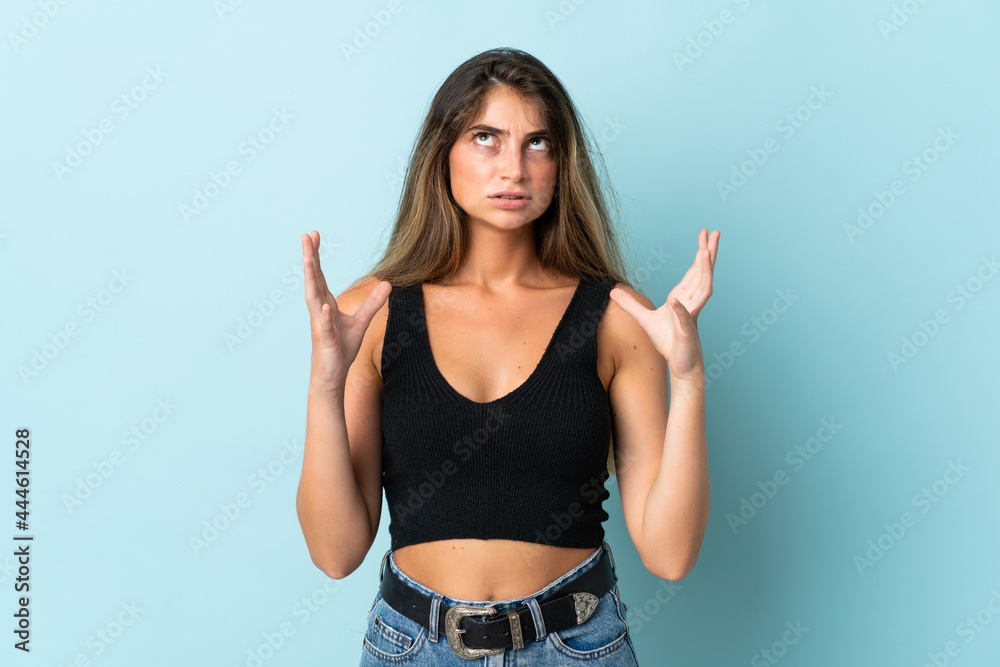 Young caucasian woman isolated on blue background stressed overwhelmed Young caucasian woman isolated on blue background stressed overwhelmed