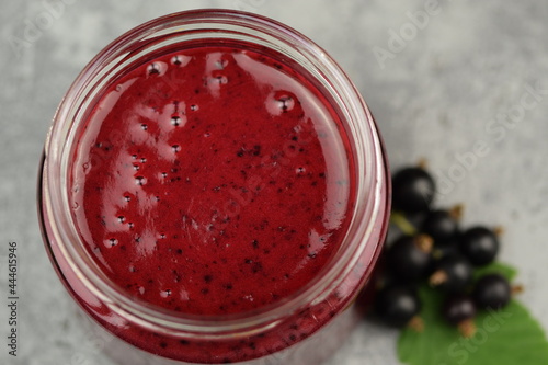 Raw blackcurrants jamin a glass jar. photo