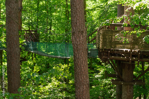 Rope footbridges located in the forest a high altitude among the lush foliage of trees. Entertainment in nature. © Viktoria