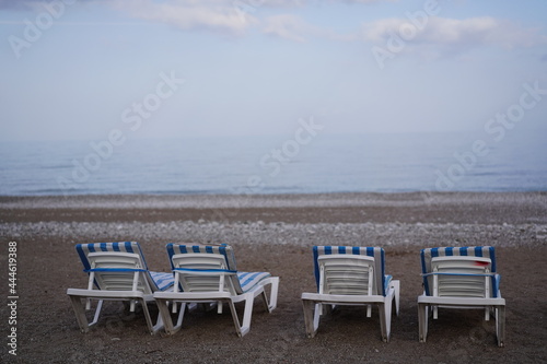 sunbeds in tranquil beach © neslihan