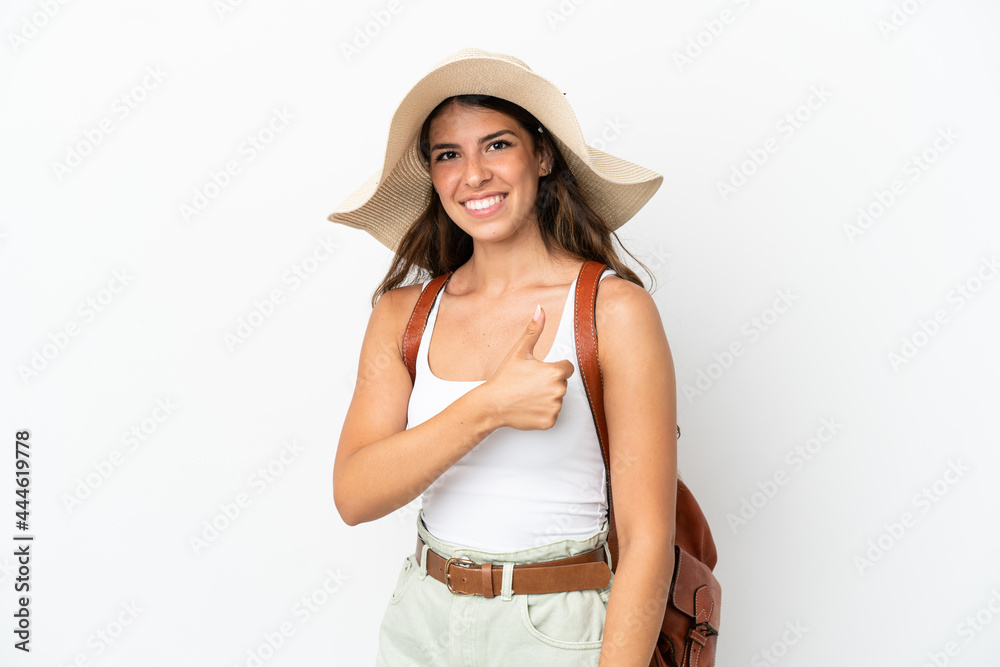 Young caucasian woman wearing a Pamela in summer holidays isolated on white background giving a thumbs up gesture Young caucasian woman wearing a Pamela in summer holidays isolated on white background giving a thumbs up gesture