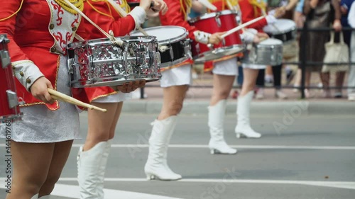 Young girls drummer in red vintage uniform at the parade. Street performance. Parade of majorettes