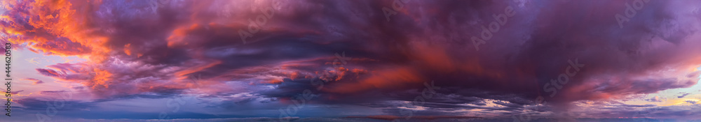 Dramatic panorama of vibrant sunset with burning sky
