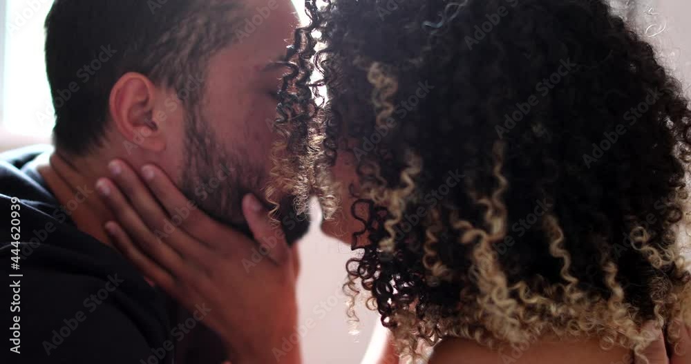 Hispanic couple kissing, candid romantic people kiss