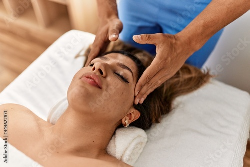 Woman reciving head massage at beauty center.