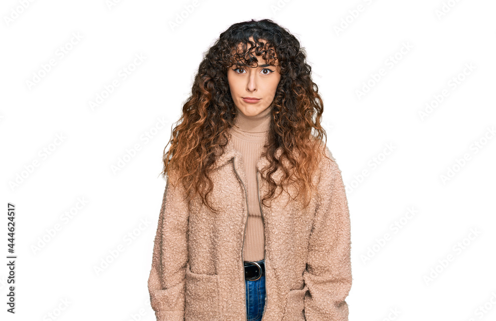 Young hispanic girl wearing winter clothes skeptic and nervous, frowning upset because of problem. negative person. Young hispanic girl wearing winter clothes skeptic and nervous, frowning upset because of problem. negative person.