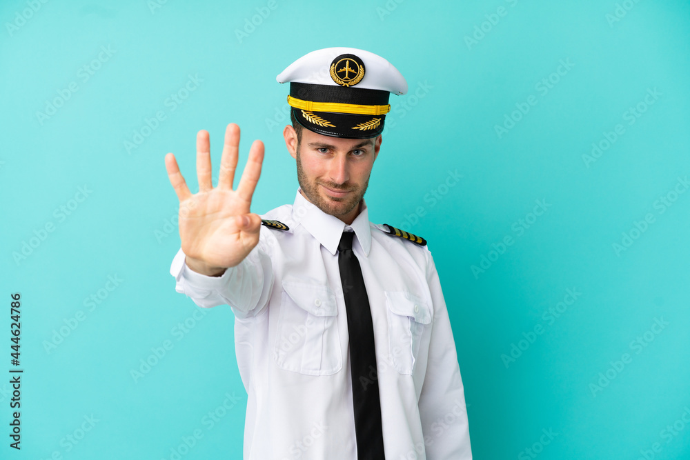Airplane caucasian pilot isolated on blue background happy and counting four with fingers