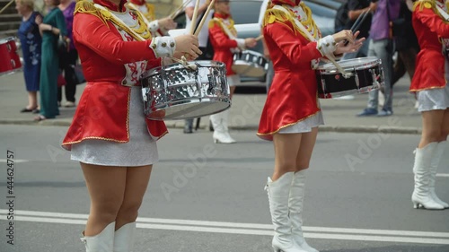 Young girls drummer in red vintage uniform at the parade. Street performance. Parade of majorettes photo