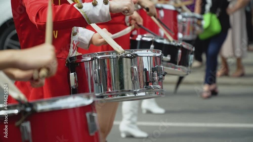 Young girls drummer in red vintage uniform at the parade. Street performance. Parade of majorettes photo