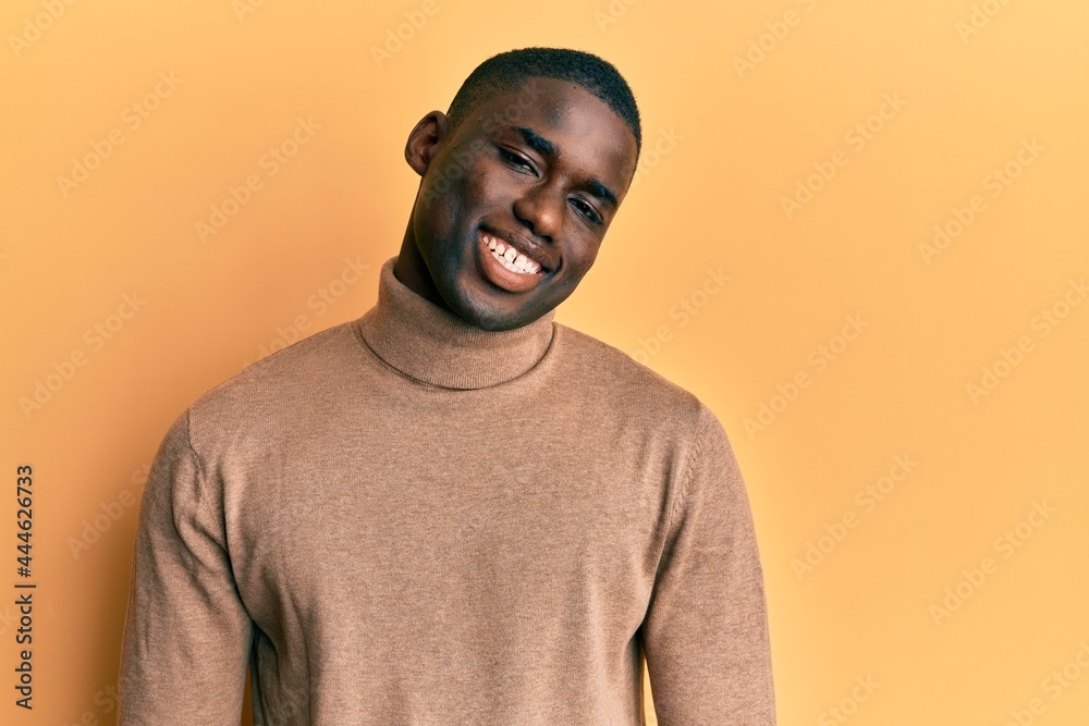 Young african american man wearing casual winter sweater with a happy and cool smile on face. lucky person.