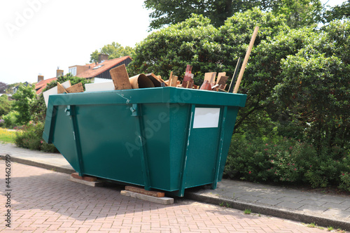 Loaded garbage dumpster photo