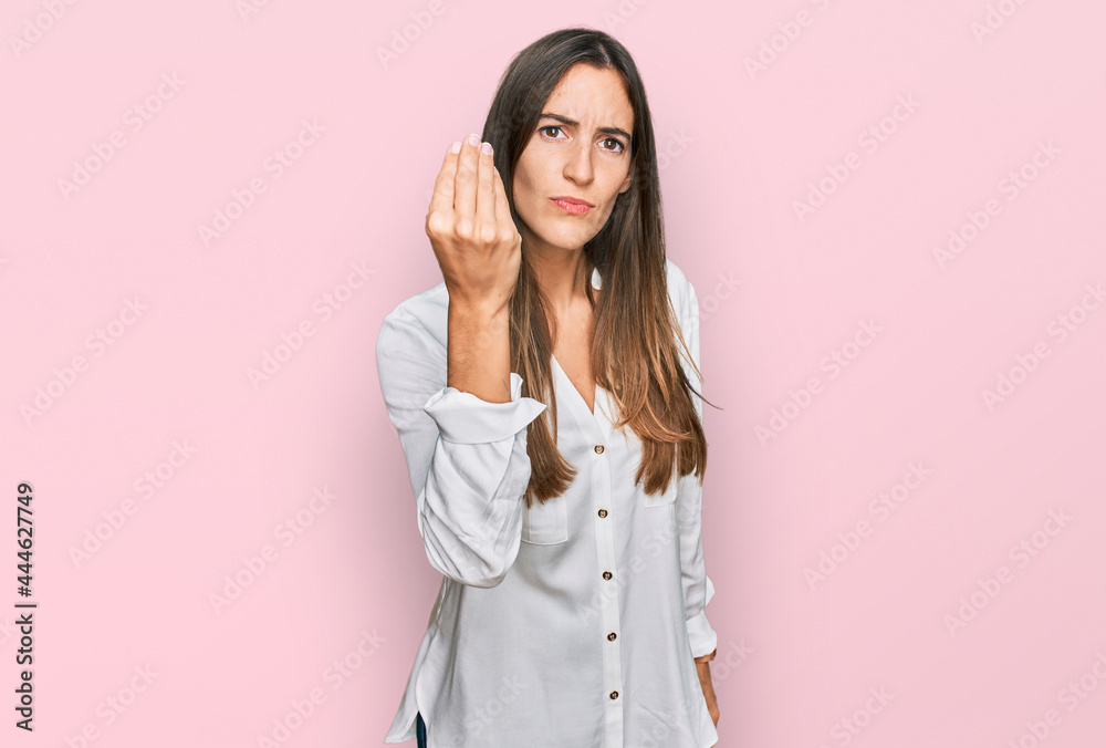 Young beautiful woman wearing casual clothes doing italian gesture with hand and fingers confident expression Young beautiful woman wearing casual clothes doing italian gesture with hand and fingers confident expression