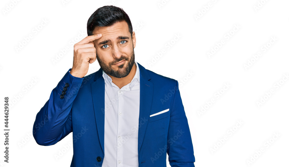 Young hispanic man wearing business jacket pointing unhappy to pimple on forehead, ugly infection of blackhead. acne and skin problem Young hispanic man wearing business jacket pointing unhappy to pimple on forehead, ugly infection of blackhead. acne and skin problem