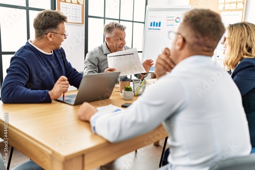 Group of middle age business workers working at the office.