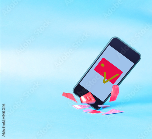 Phone with a credit card on a blue background. Online banking concept