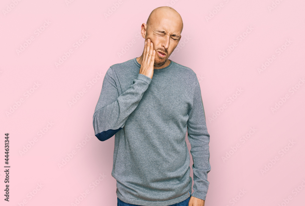 Bald man with beard wearing casual clothes touching mouth with hand with painful expression because of toothache or dental illness on teeth. dentist Bald man with beard wearing casual clothes touching mouth with hand with painful expression because of toothache or dental illness on teeth. dentist