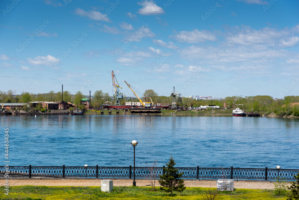 View of the sunny summer embankment of the Angara river in Irkutsk, Russia