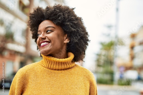 Young african american girl smiling happy standing at the city.