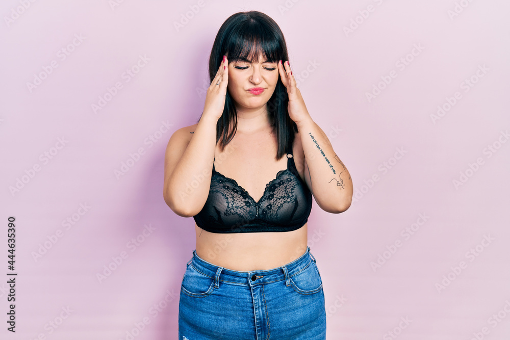Young hispanic woman wearing lingerie suffering from headache desperate and stressed because pain and migraine. hands on head. Young hispanic woman wearing lingerie suffering from headache desperate and stressed because pain and migraine. hands on head.