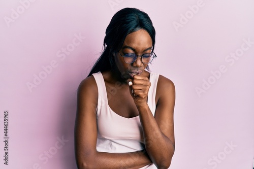 Young african american woman wearing casual clothes and glasses feeling unwell and coughing as symptom for cold or bronchitis. health care concept.