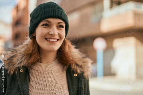 Young caucasian girl smiling happy standing at the city.