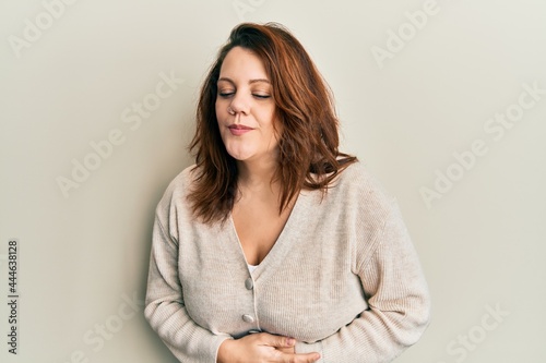 Young caucasian woman wearing casual clothes with hand on stomach because indigestion, painful illness feeling unwell. ache concept.