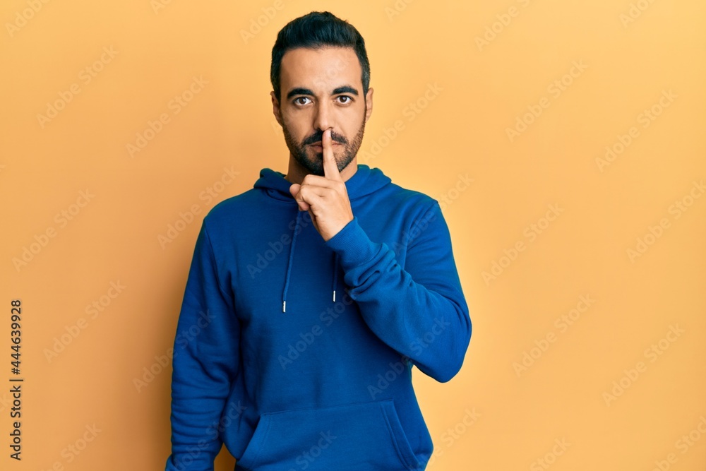 Young hispanic man wearing casual clothes asking to be quiet with finger on lips. silence and secret concept. Young hispanic man wearing casual clothes asking to be quiet with finger on lips. silence and secret concept.