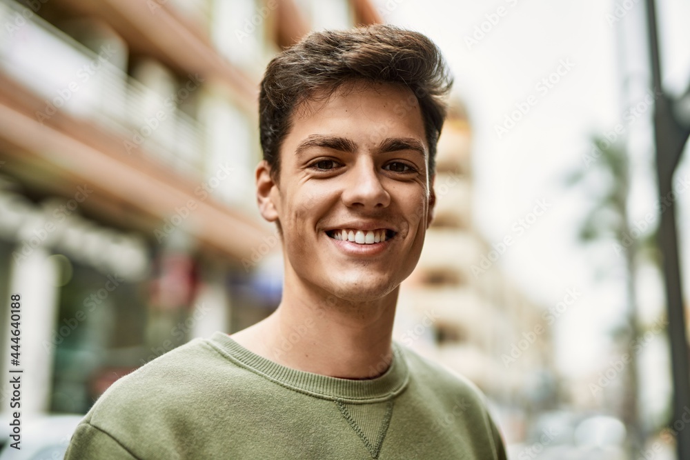 Young hispanic man smiling happy standing at the city. Young hispanic man smiling happy standing at the city.