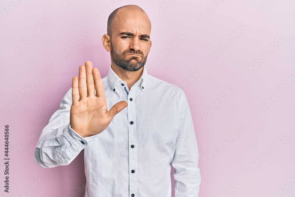 Young hispanic man wearing casual clothes doing stop sing with palm of the hand. warning expression with negative and serious gesture on the face. Young hispanic man wearing casual clothes doing stop sing with palm of the hand. warning expression with negative and serious gesture on the face.