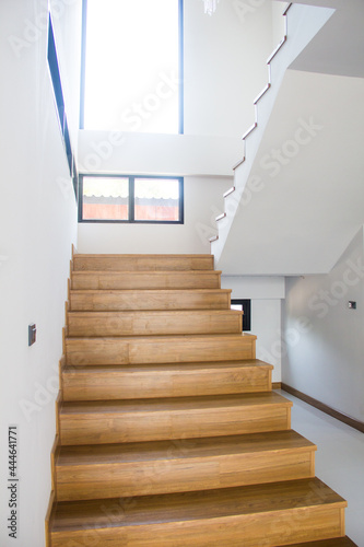 Modern natural tree wooden stairs in new house interior,Wooden stairs at modern,White wall.