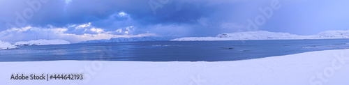 A patch of snow and ice in the village of Teriberka, Murmansk, Russia. Mar. 2017 Fishing ship graveyard in Barents sea. The polar climate of the Arctic.