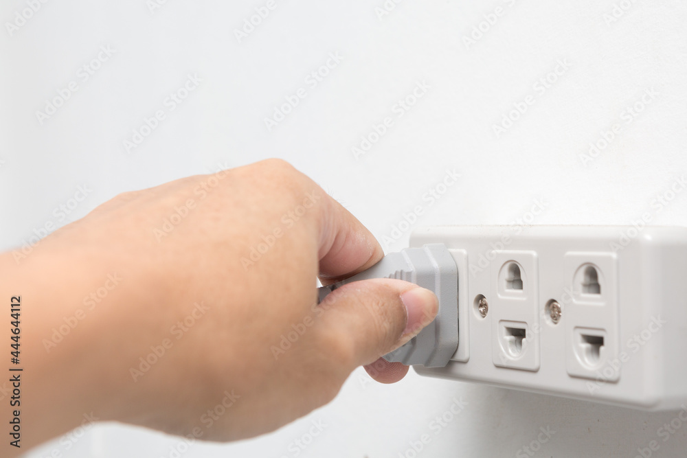 Hands holding plugged in power socket on white background Hands holding plugged in power socket on white background