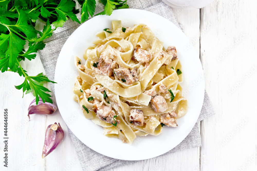 Pasta with salmon and cream on board top