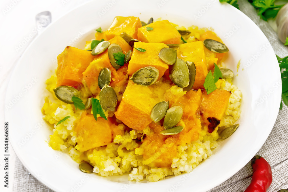 Porridge millet with spicy pumpkin in plate on board Porridge millet with spicy pumpkin in plate on board