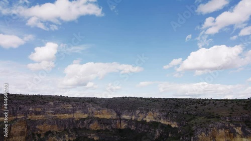 River Meander Among Cliffs In Hoces del Rio Duraton Natural Park With Hermitage Of Convent de la Hoz In Sebulcor, Segovia, Spain. tilt down reveal photo