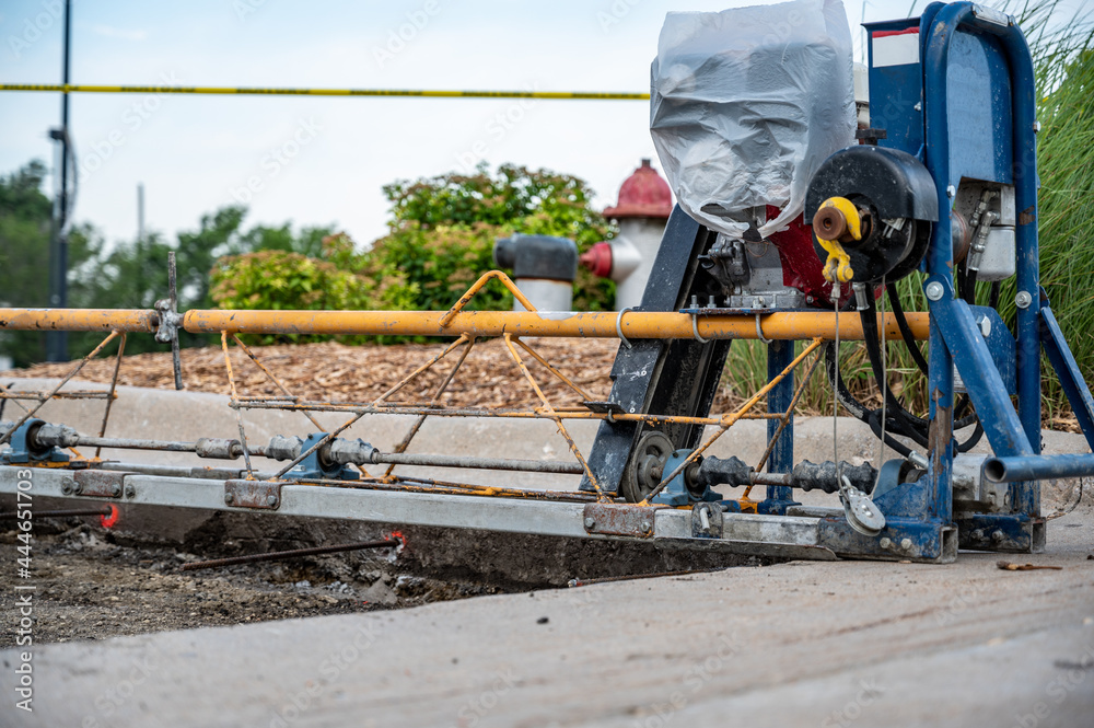 Power screed setup and ready for pouring concrete on prepared subbase of a road repair Power screed setup and ready for pouring concrete on prepared subbase of a road repair