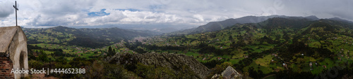 panoramic view of a chapel on a mountain with other mountains in the background © Eduard