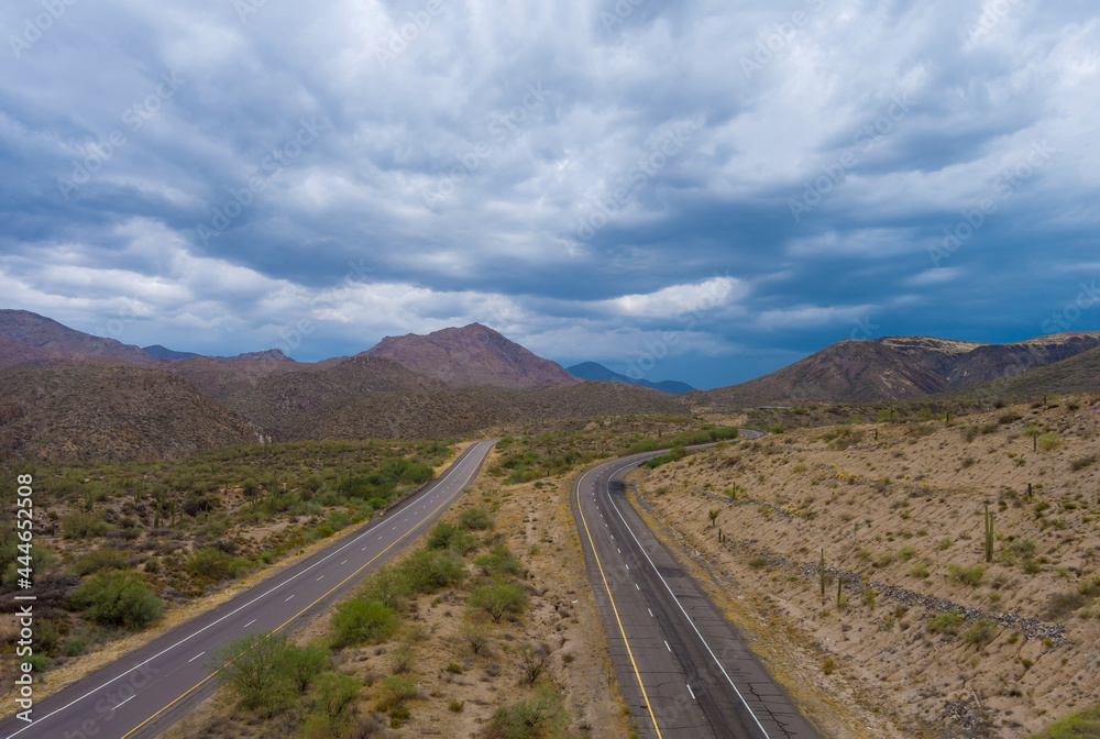 Aerial view highway across the arid desert Arizona mountains adventure traveling desert road