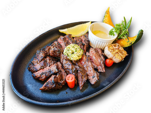Steak with medium rare in plate with garlic herb lemon pumpkin side dish and signature sauce on white background die cut with clipping path