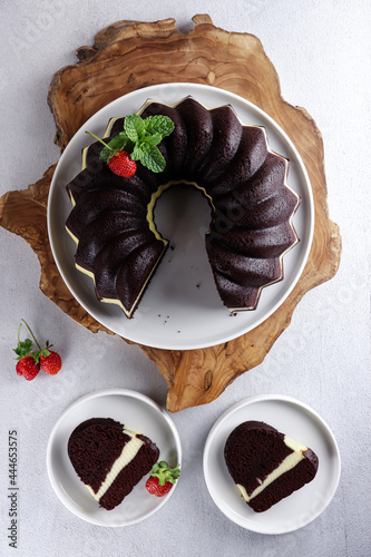 Brownies Kukus Keju or Steamed cheese bundt cake, an Indonesian rendition of the famous American brownies, on white plate. photo