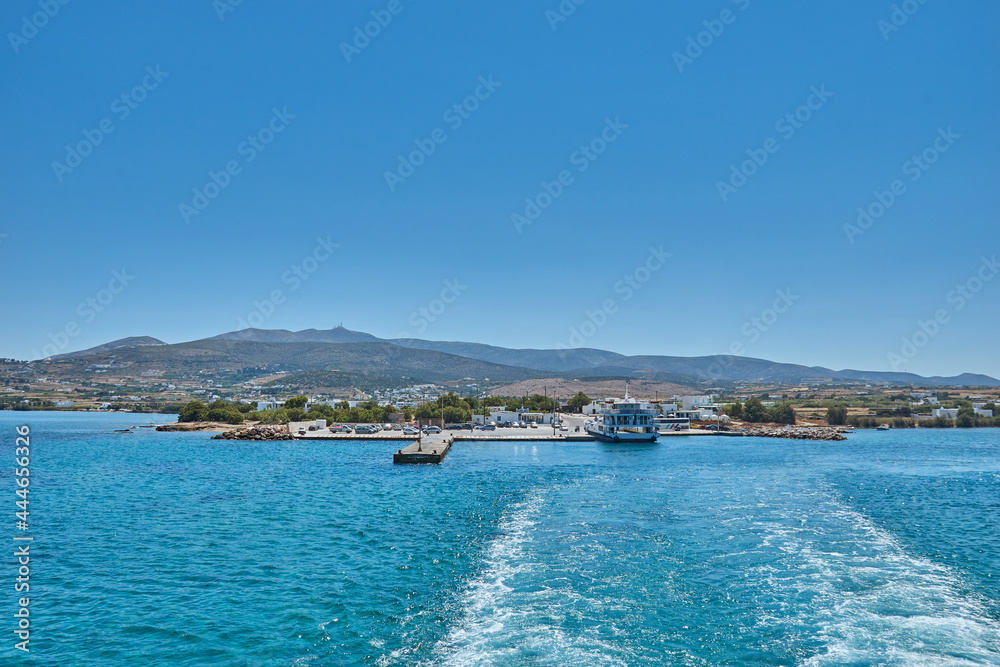 Fototapeta premium Antiparos island, Greece - June 2017: Beautiful seascape view travelling to Antiparos island as the boat approaches the port. Panoramic summer scenery in Greece at Antiparos island, Cyclades, Greece