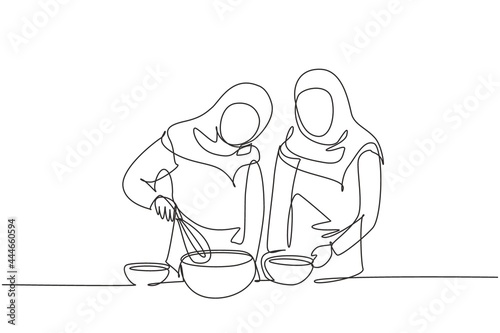 Single continuous line drawing two Arab woman talks on smartphone while preparing dinner in cozy kitchen and knead cake dough using manual hand mixer. One line draw graphic design vector illustration