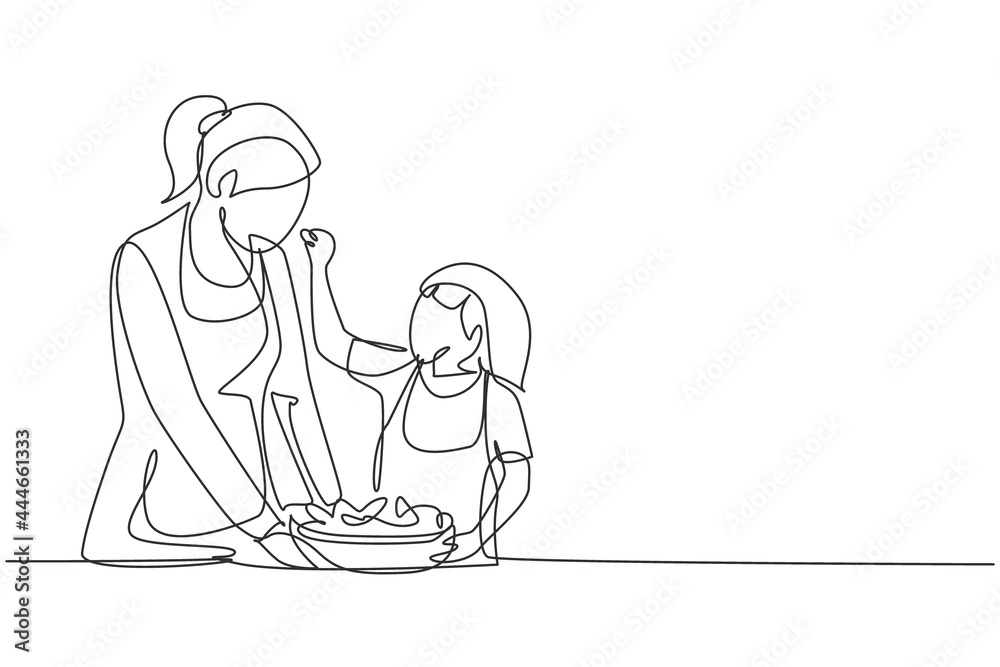 Single one line drawing mother feeds her little daughter food and in front of her is bowl filled with salad. Cooking together in cozy kitchen. Continuous line draw design graphic vector illustration