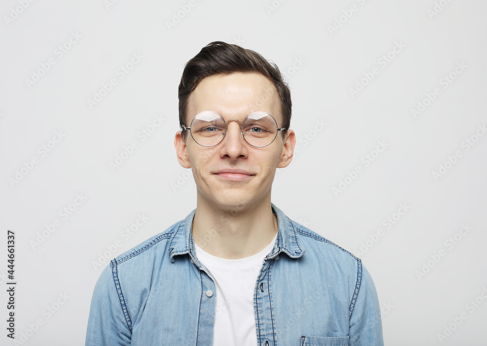 Portrait of confident young man on light background