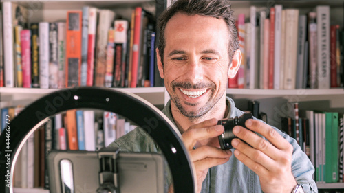 Young man recording a photography course for social media, his blog or his website. Concept of online courses.