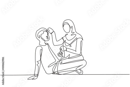 Single one line drawing romantic Arabian couple having picnic in park. Relaxing together sitting on the ground and women feeding grapes to men. Continuous line draw design graphic vector illustration