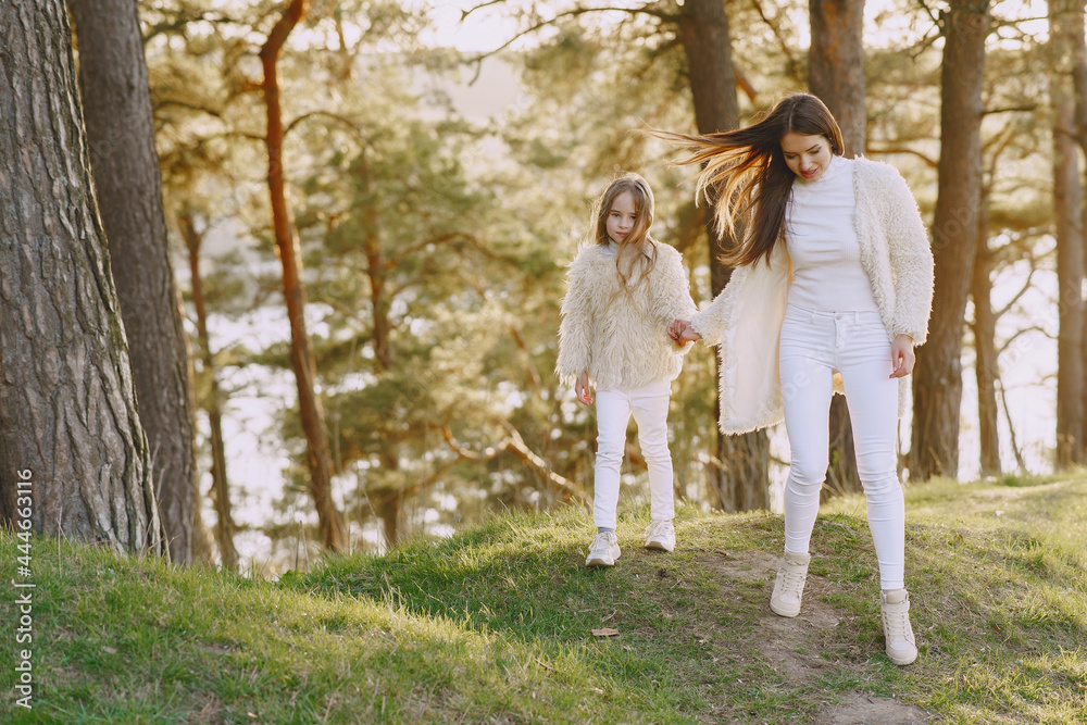 Elegant mother with daughter in a summer forest Elegant mother with daughter in a summer forest