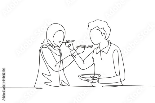 Single continuous line drawing romantic Arabic couple feeding each other. Having fun dinner together at restaurant. Celebrate wedding anniversaries. One line draw graphic design vector illustration